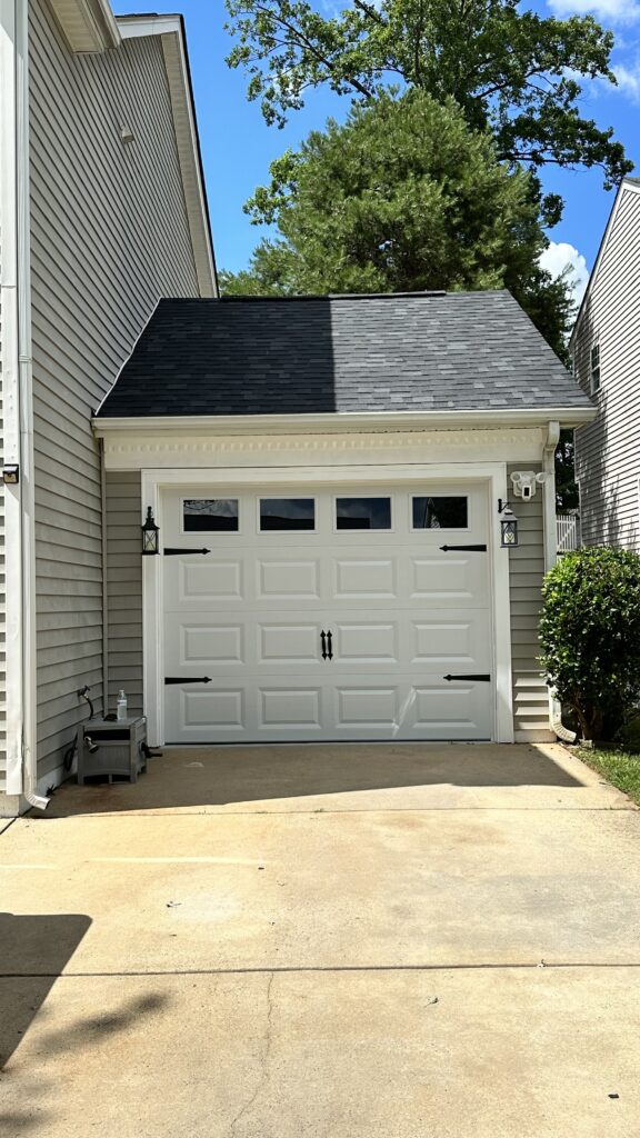 White traditional garage door with handles and hinges. 