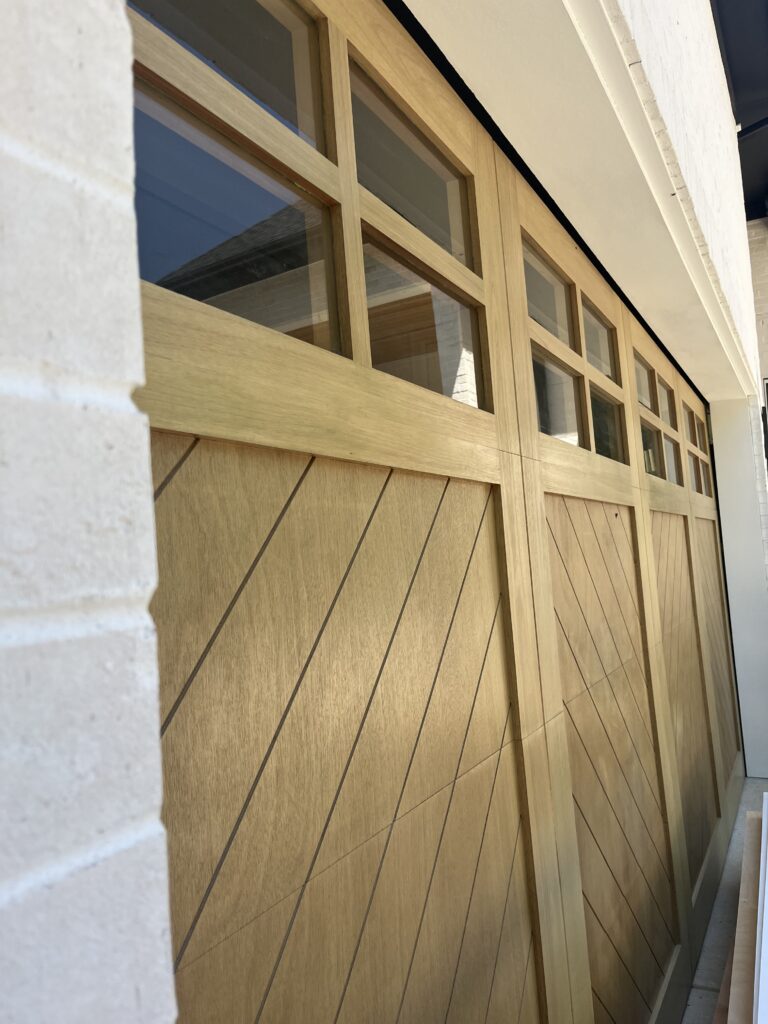 custom wood garage door with an overlay