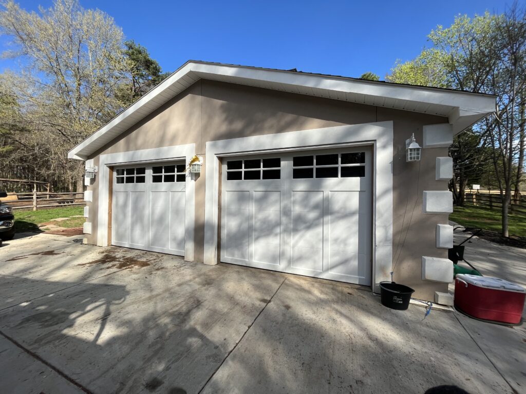 Two white garage doors with windows